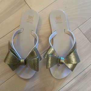 Mel by Melissa bow glitter flip flops
